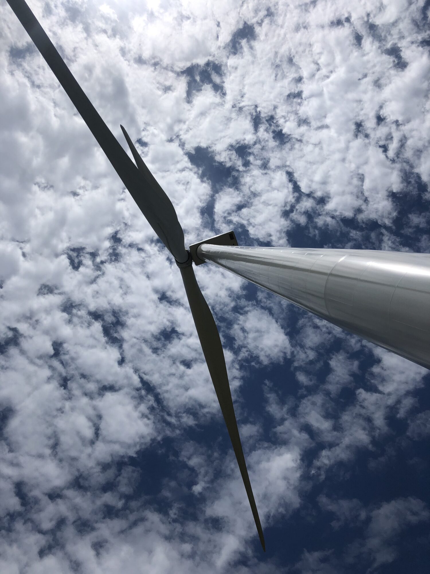 Picture of a wind turbine looking up from below.