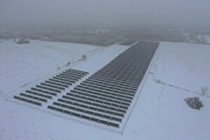Birds-eye view of a solar farm in a snowy field