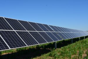 Burt County solar array in a green field with a blue sky in the background